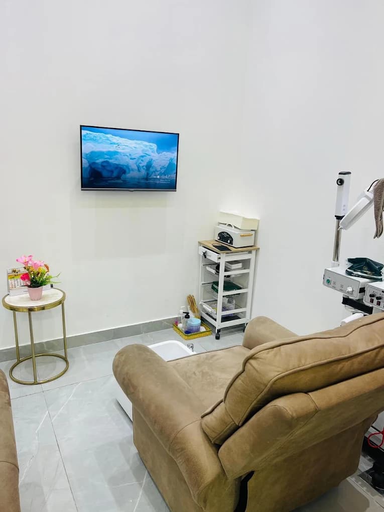 Spa waiting area with a recliner chair and wall-mounted TV